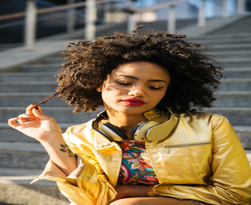 Woman sitting on stairs playing with her hair